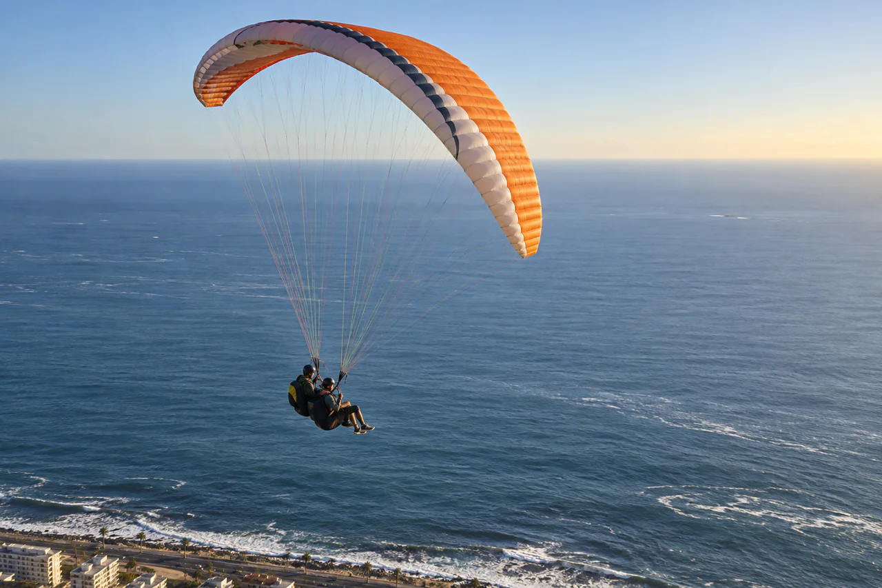 A tandem paraglider above Cape Town and the Atlantic Seaboard